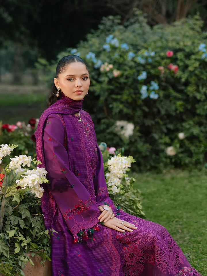 Luxury Gulfraz lawn fabric 105-B displayed on a hanger with intricate floral pattern in vibrant colors.