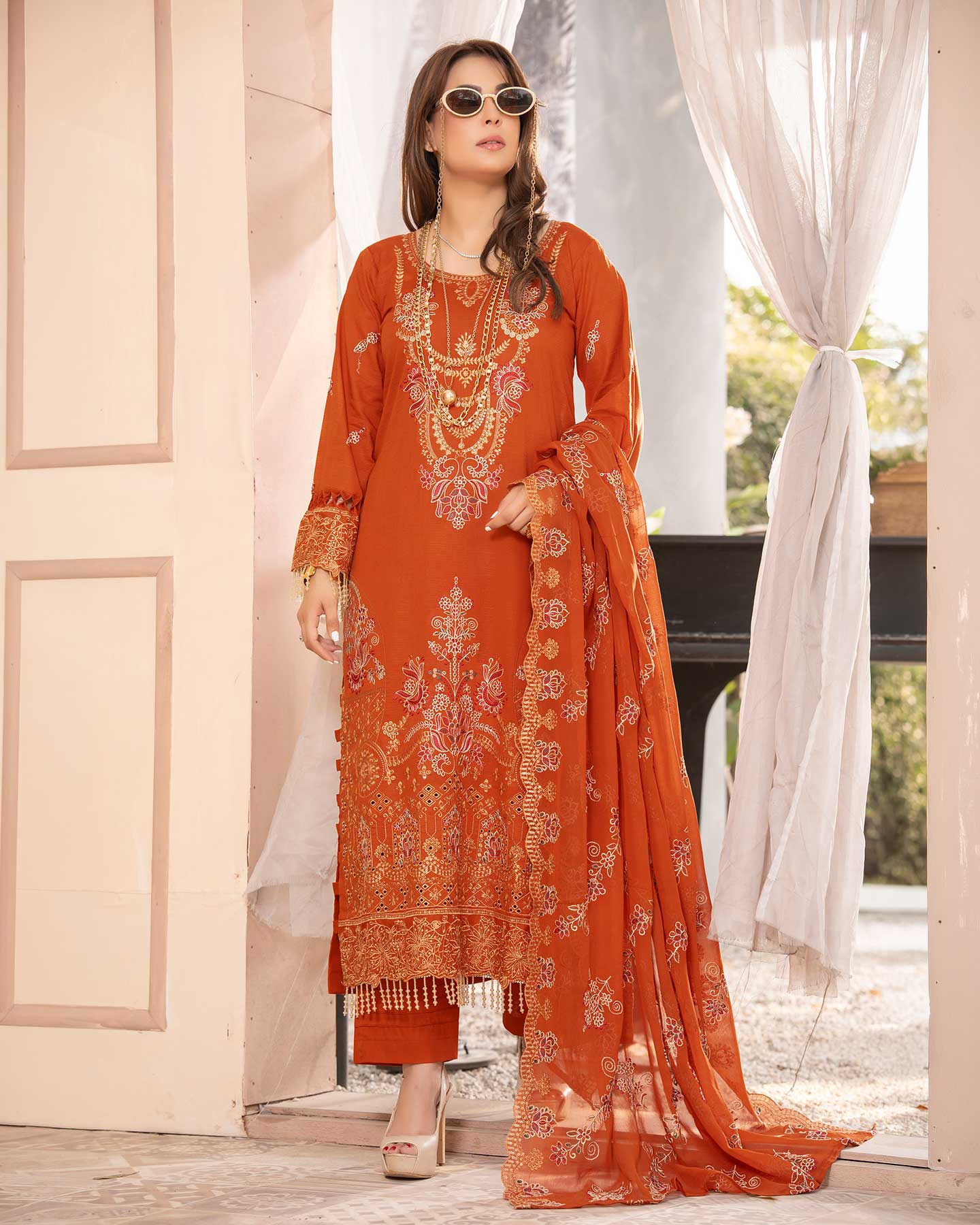 Embroidered Gulfraz lawn fabric D 06 with intricate embroidery in vibrant colors, displayed in a close-up view of the textile.