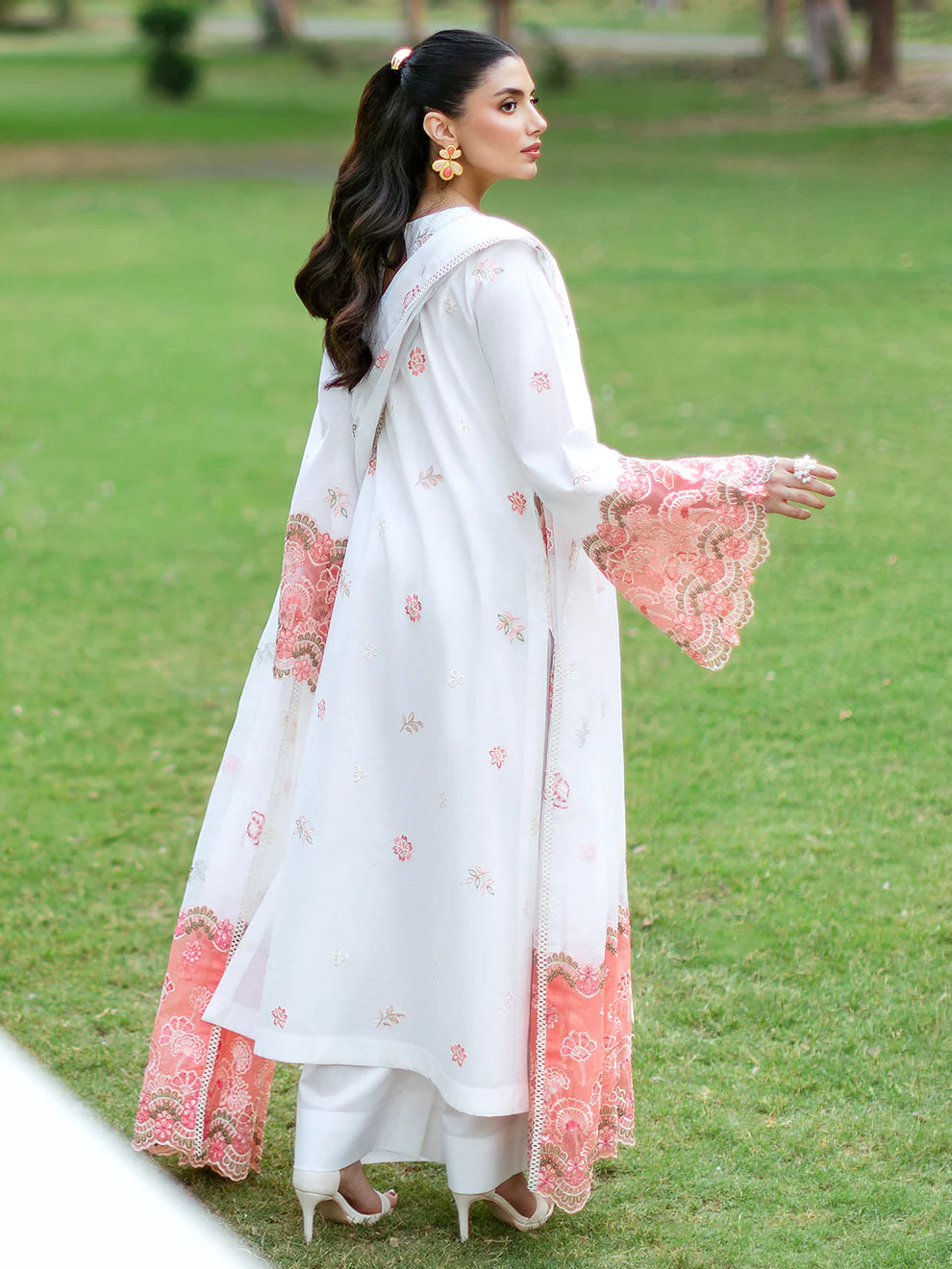 Luxury Gulfraz Lyra lawn fabric swatch showcasing a vibrant, intricate pattern in rich colors on a soft, high-quality textile background.